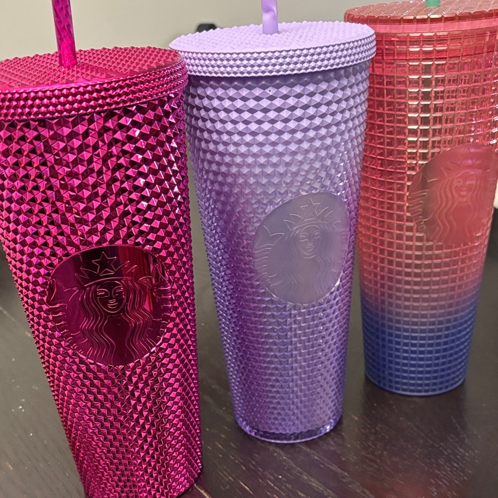 3 Starbucks cups with straws